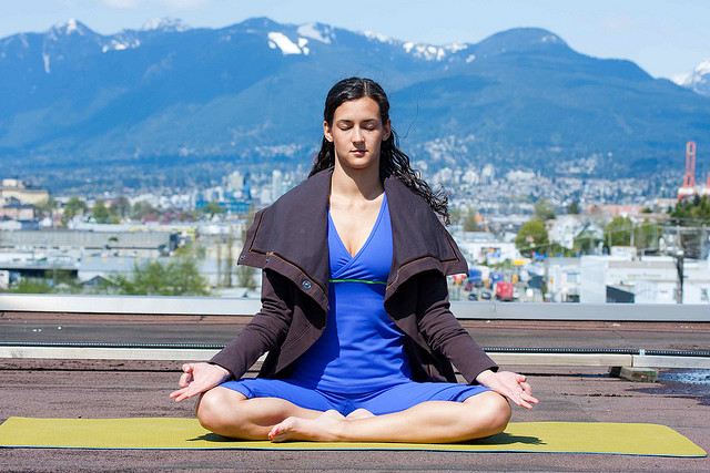 LulemonAthletica woman doing yoga in mountains
