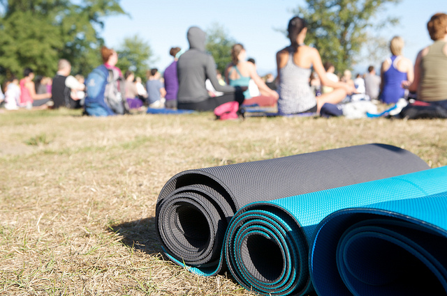 Yoga group yoga class with matts in foreground