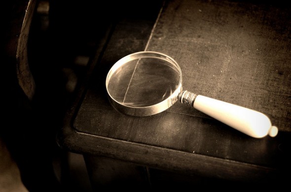 magnifying glass and closed book magnifying glass and closed book