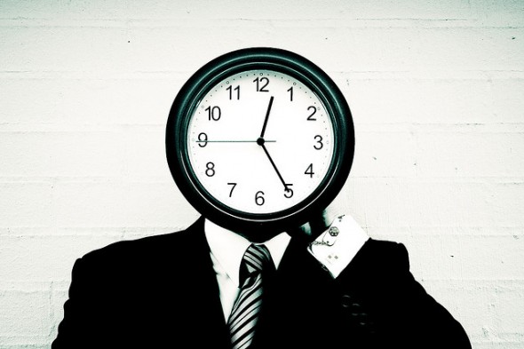 man with clock for face