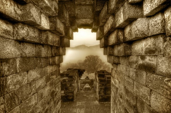 Stone archway looks on to forest
