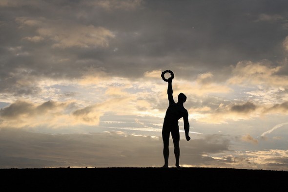 Statue in victory pose on horizon
